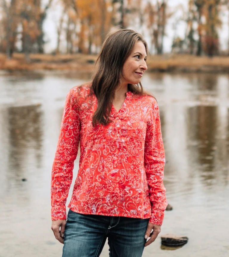 Dr. Camilla Petersen standing by a serene river in Missoula, Montana, representing personalized care at Petersen Concierge Medicine.